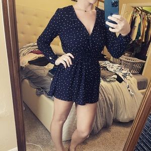Navy blue long sleeve romper wit white polka dots